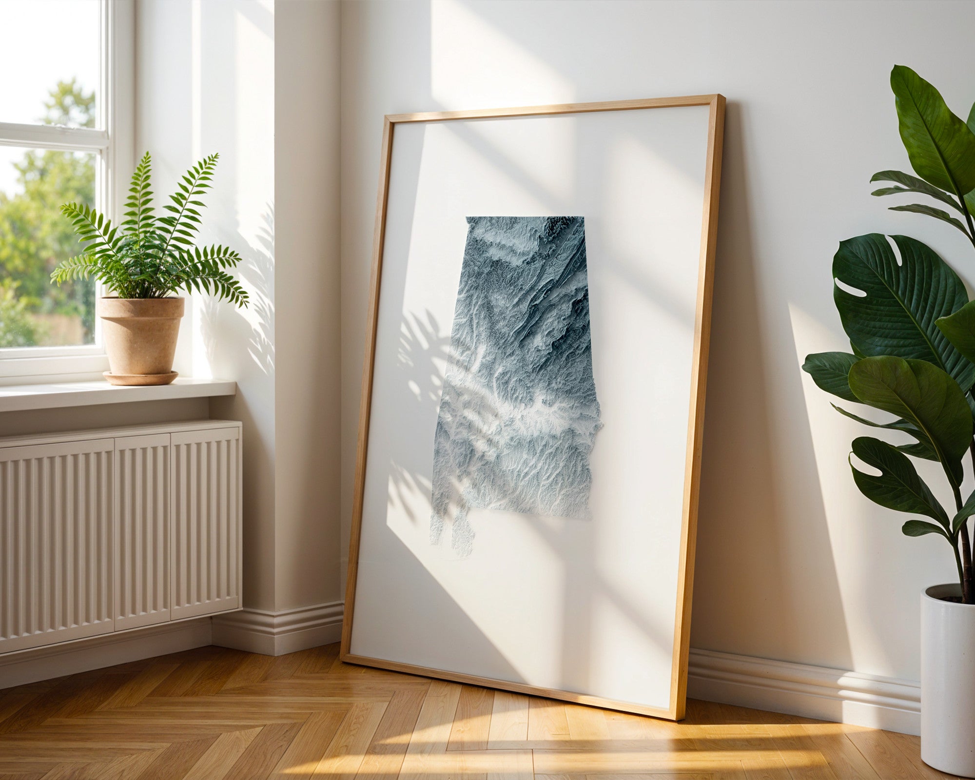 A minimalist elevation map poster of Alabama hanging on a wall
